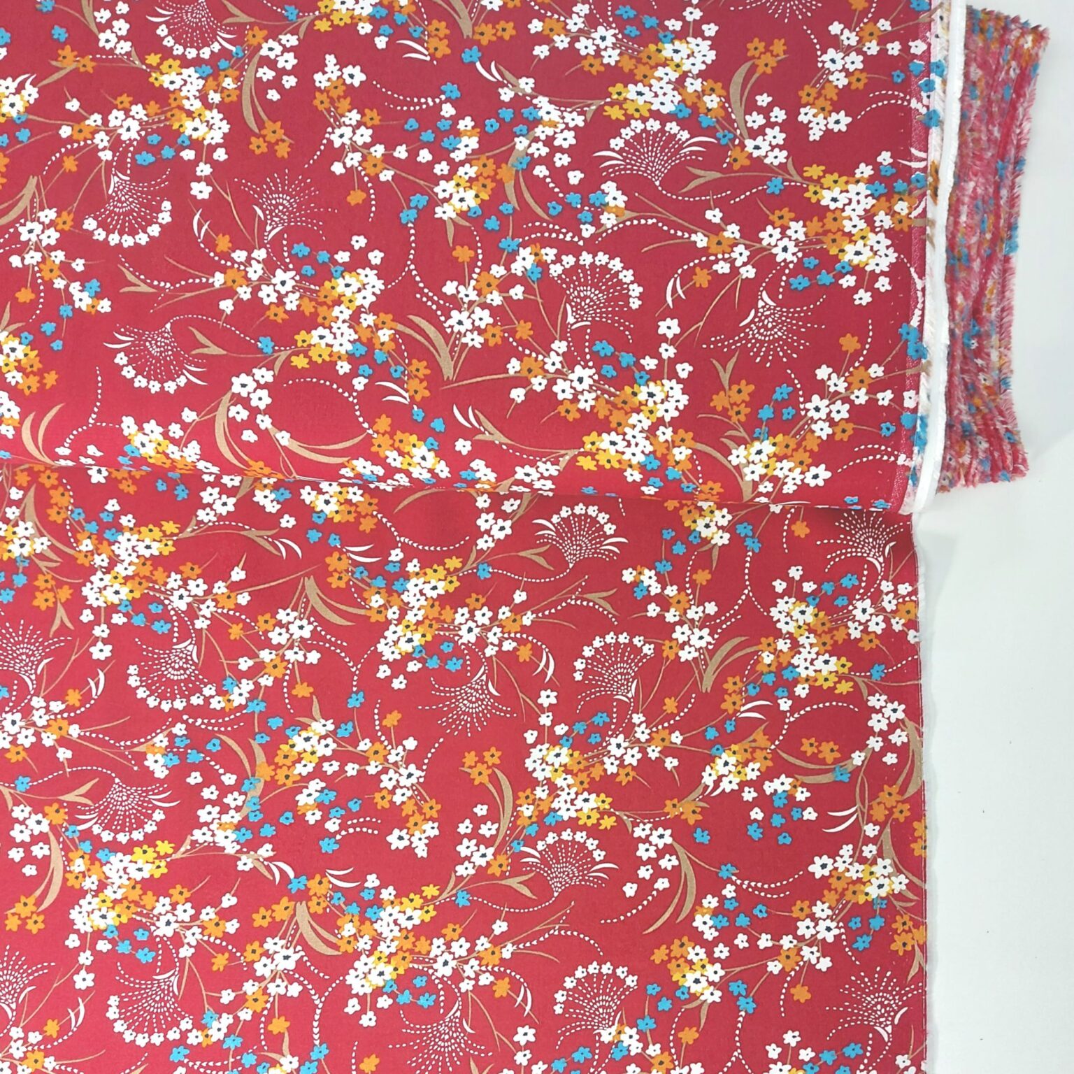 Floral spray on red viscose fabric | More Sewing