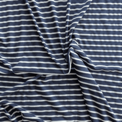 Viscose Blend Fabric Woven Stripe Jersey Fabric In Navy And White. 4 Way Stretch Woven Stripe Fabric.  Navy stripe approx 8mm wide. White stripe approx 4mm wide. Very soft, lightweight drapey jersey.