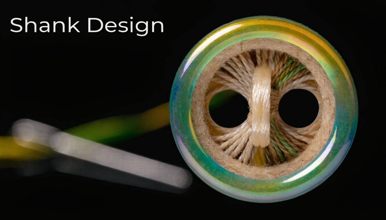 A close-up view of an iridescent button with a central loop shank over a dark background.