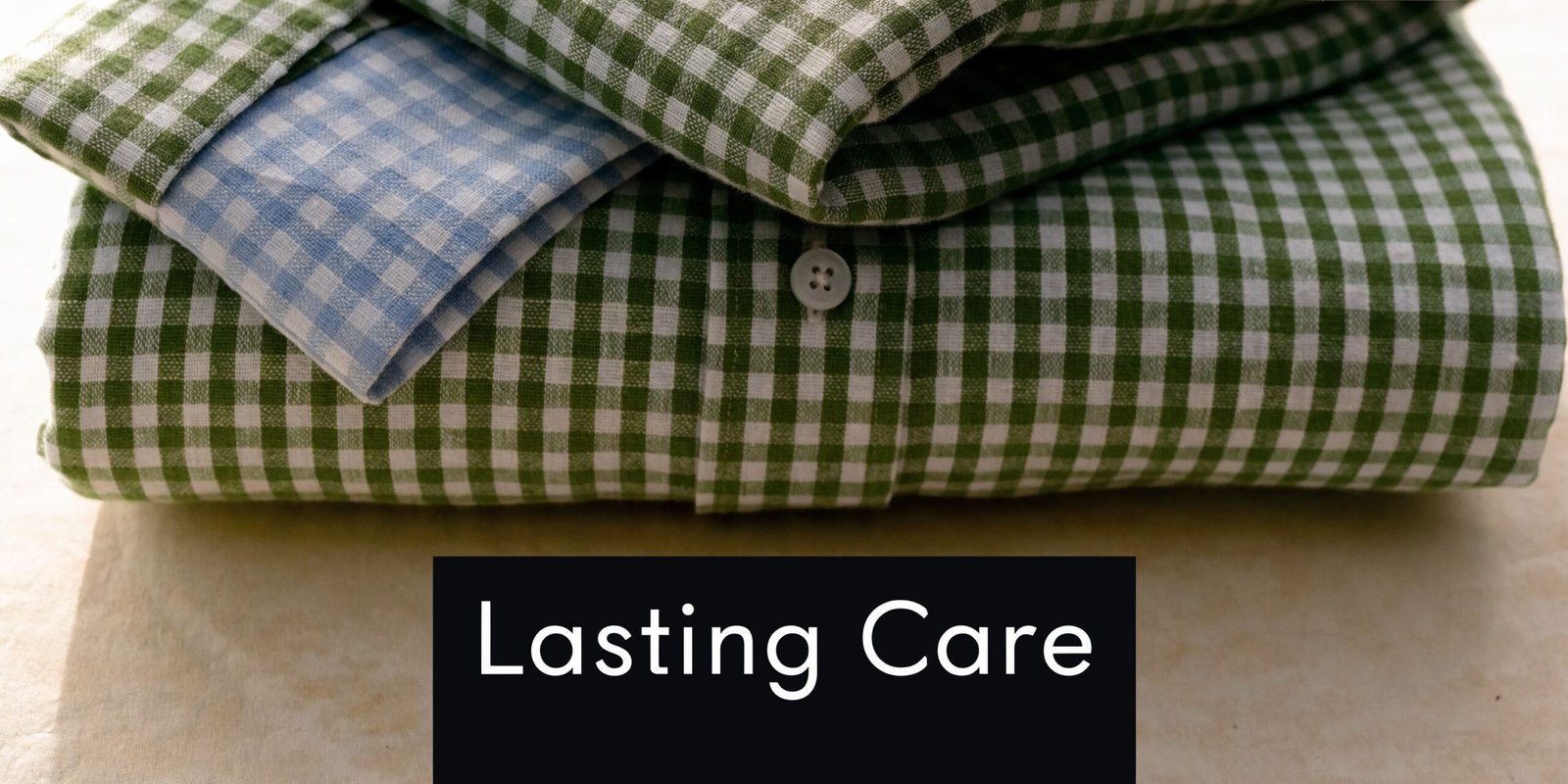 A stack of folded green and white checkered gingham linen fabric with a blue checkered corner detail.