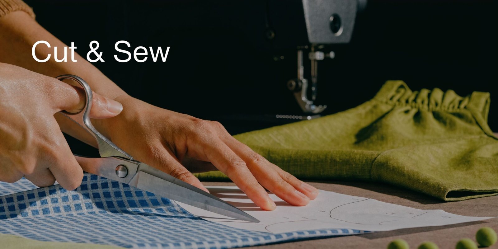 Pattern for Halter Top: A UK Sewing Guide 3 A close-up view of hands using large sewing scissors to cut fabric around a paper pattern.