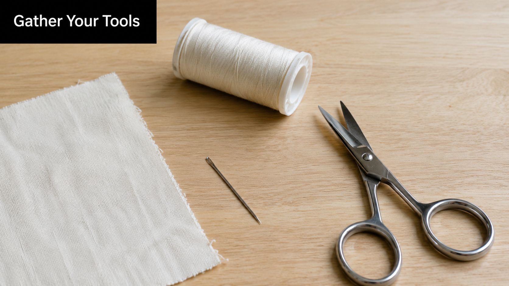 A close-up view of essential sewing tools including white fabric, a spool of thread, and metal scissors.