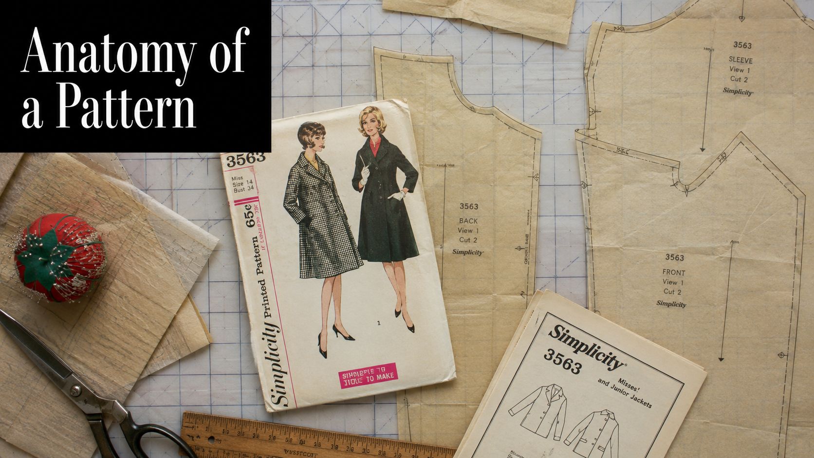 Vintage Simplicity sewing pattern pieces for a jacket laid out on a grid cutting mat with tools.