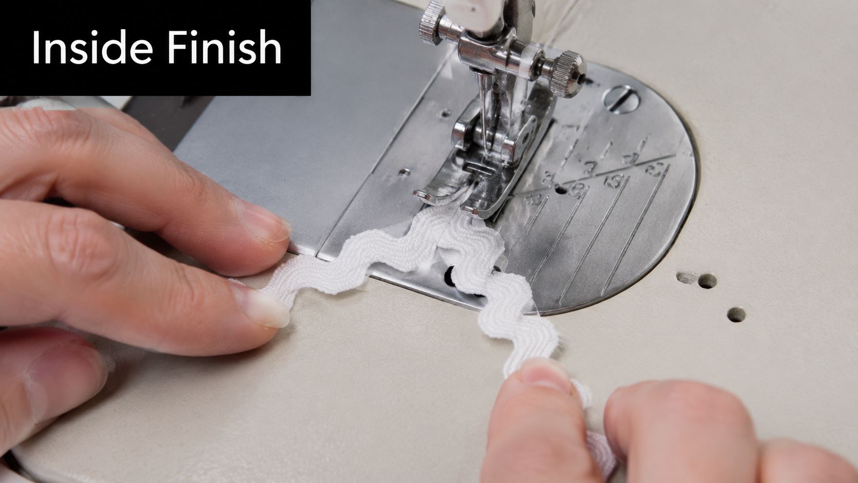 Close-up of hands sewing white ric rac trim on a sewing machine for an inside finish.